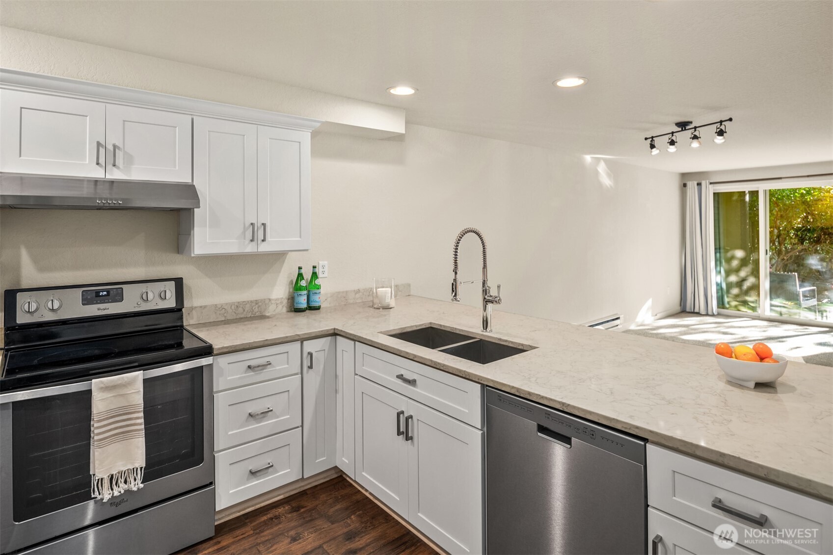 12014 98th Avenue Northeast, Unit 101 Kirkland, WA 98034 - Photo 14 of 33 a kitchen with white cabinets and appliances