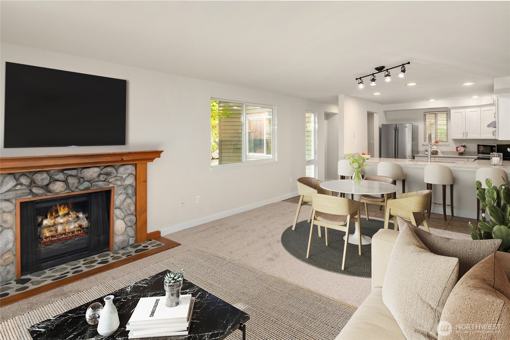 12014 98th Avenue Northeast, Unit 101 Kirkland, WA 98034 - Photo 16 of 33 a living room with furniture a flat screen tv and a fireplace