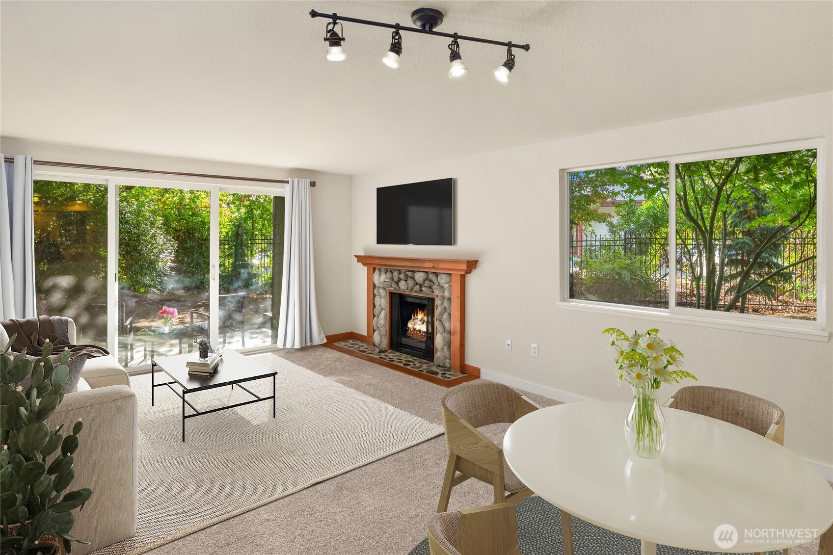12014 98th Avenue Northeast, Unit 101 Kirkland, WA 98034 - Photo 18 of 33 a living room with furniture fireplace and large windows