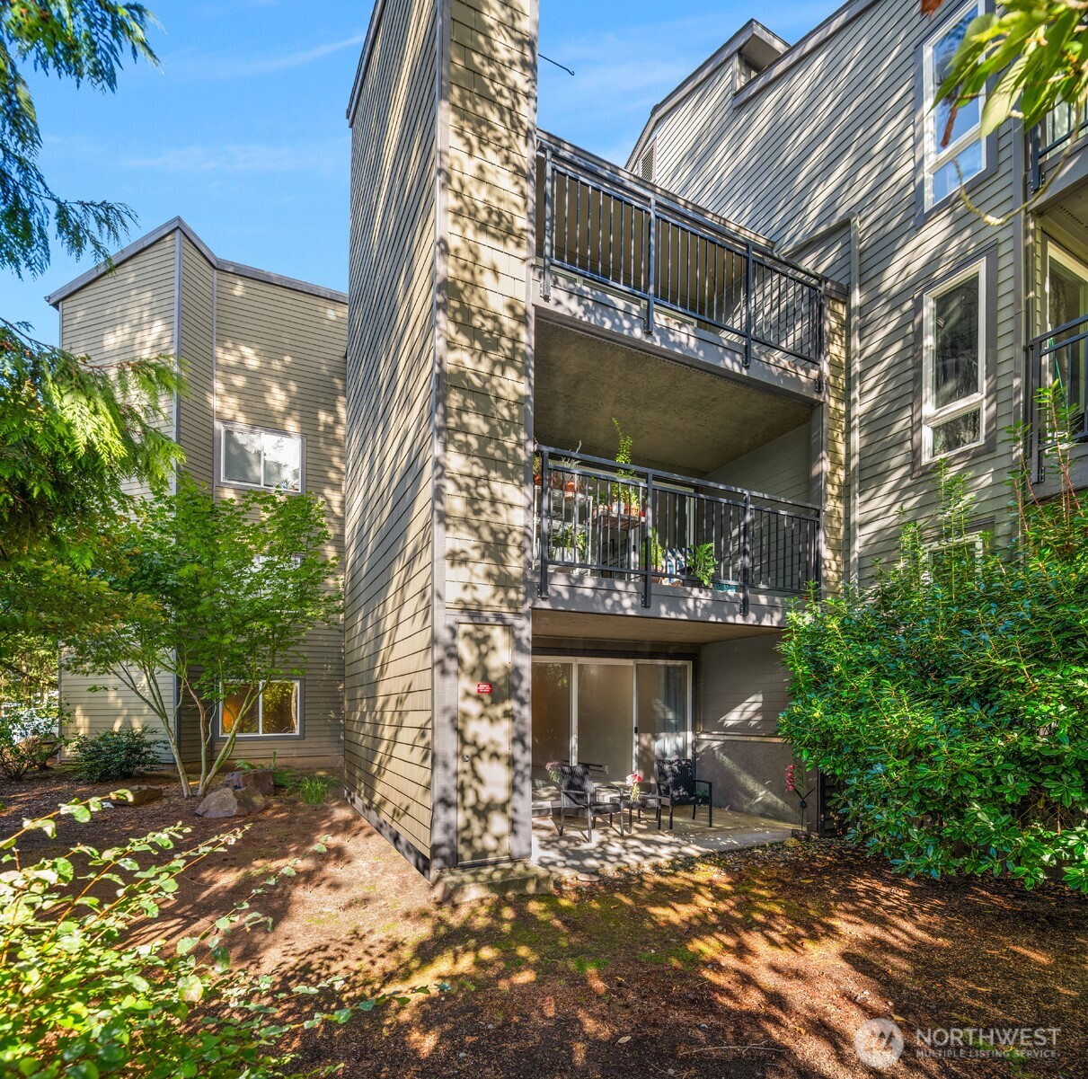 12014 98th Avenue Northeast, Unit 101 Kirkland, WA 98034 - Photo 8 of 33 a front view of a house with a yard