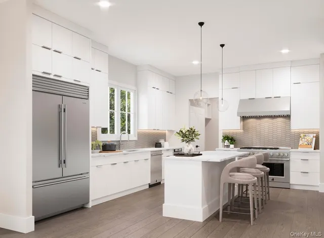 a kitchen with white cabinets and refrigerator