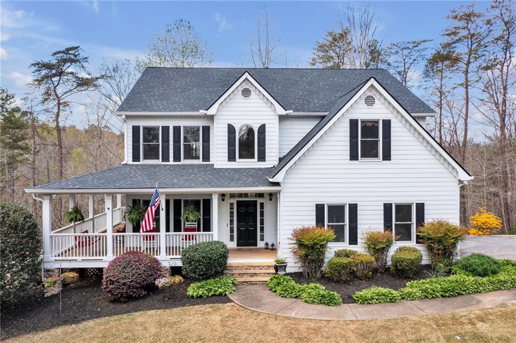 a front view of a house with garden and porch