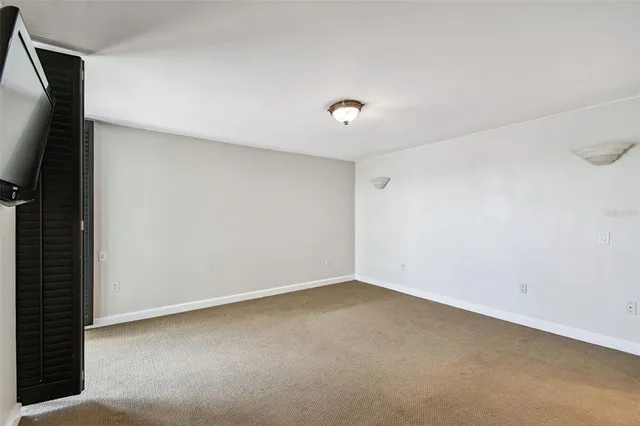 a bathroom with a granite countertop double vanity sink and mirror