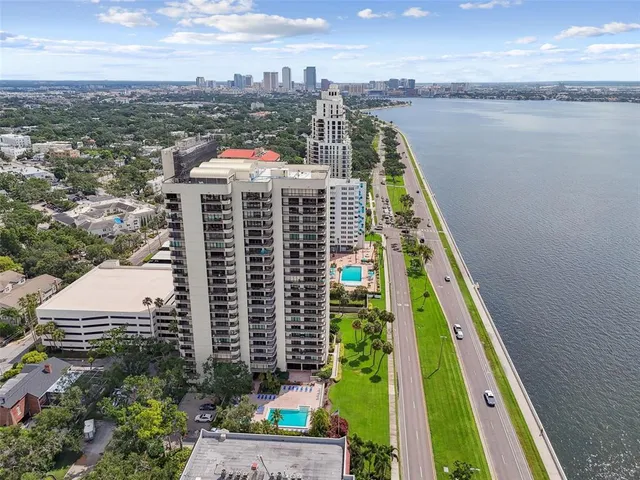 an aerial view of a house with a yard and outdoor seating