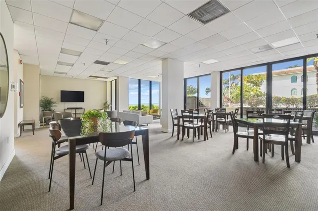 a spacious bedroom with furniture and large windows