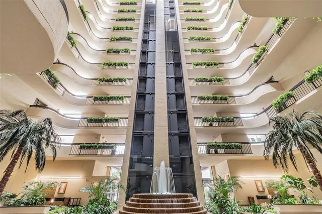 a front view of a multi story building with yard