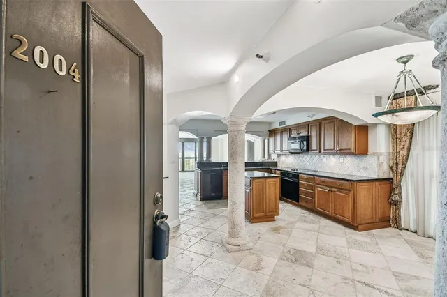 a kitchen with stainless steel appliances granite countertop a stove a sink dishwasher and a refrigerator