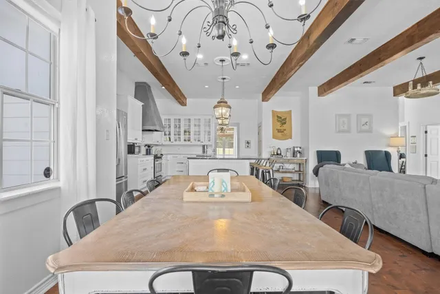 a view of a dining room with furniture and a chandelier