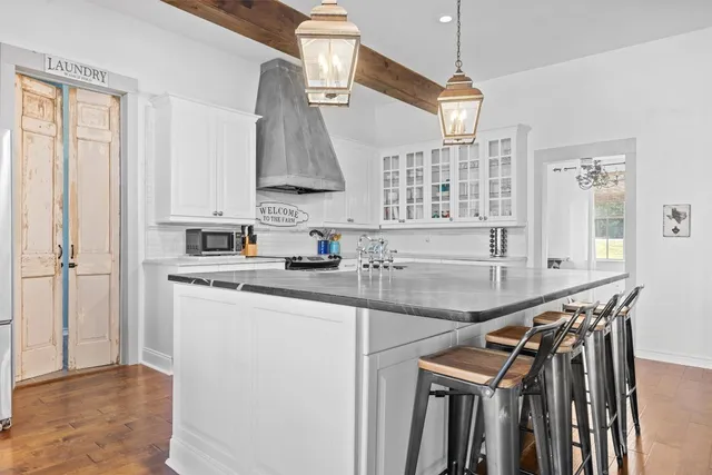 a kitchen with a sink a stove and cabinets
