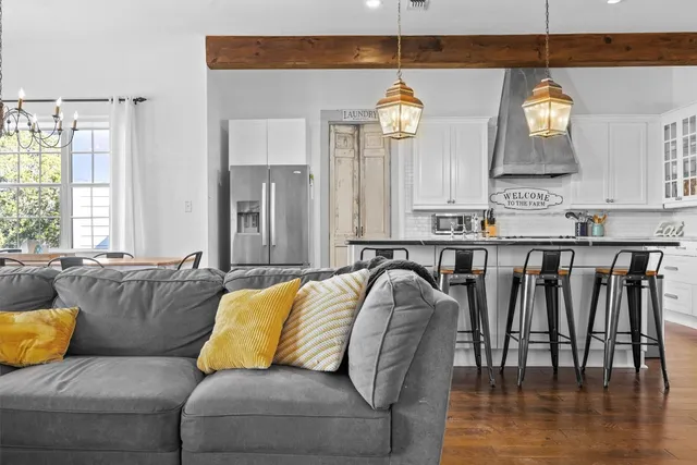a living room with furniture and kitchen view