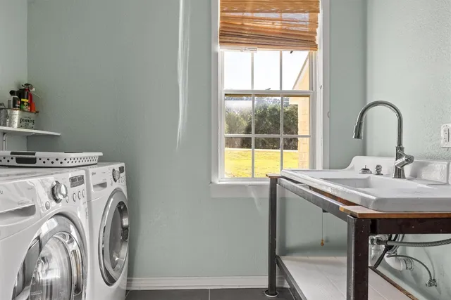 a view of a sink and washer in a kitchen