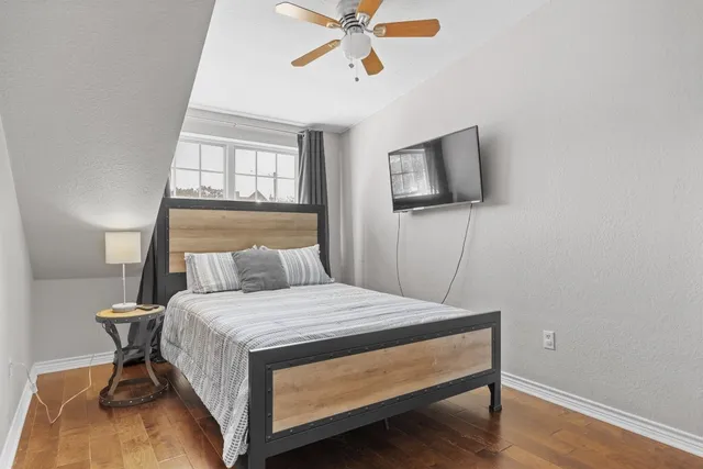 a bedroom with a bed and a flat screen tv