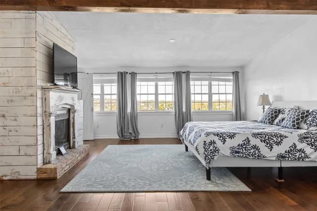 a spacious bedroom with a bed and a flat screen tv