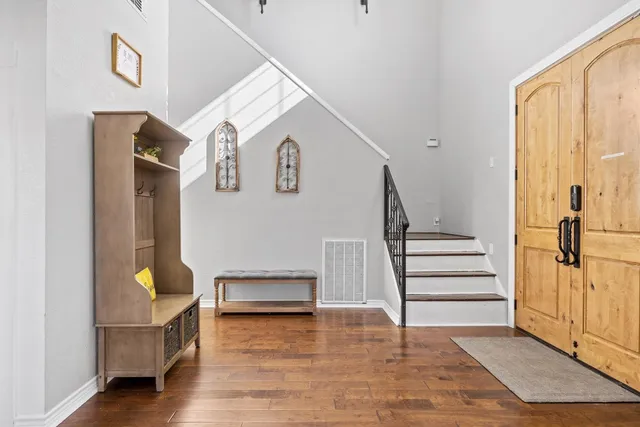 a view of entryway and hall with wooden floor
