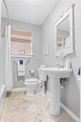 a bathroom with a sink toilet and mirror