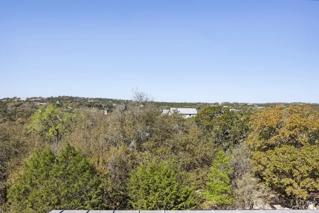 a view of a city with lush green forest