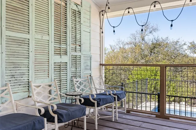 a view of a balcony with chairs