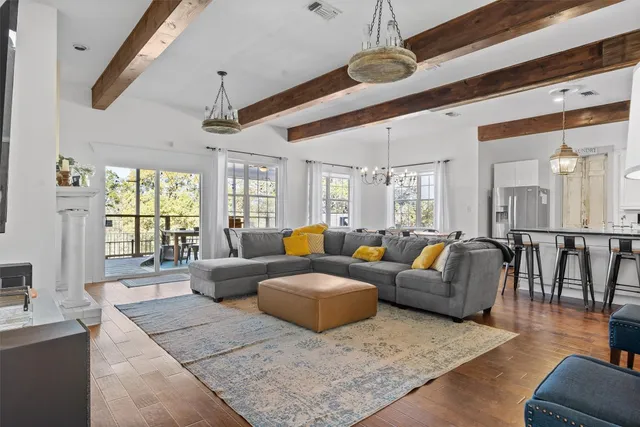 a living room with furniture wooden floor and ceiling fan
