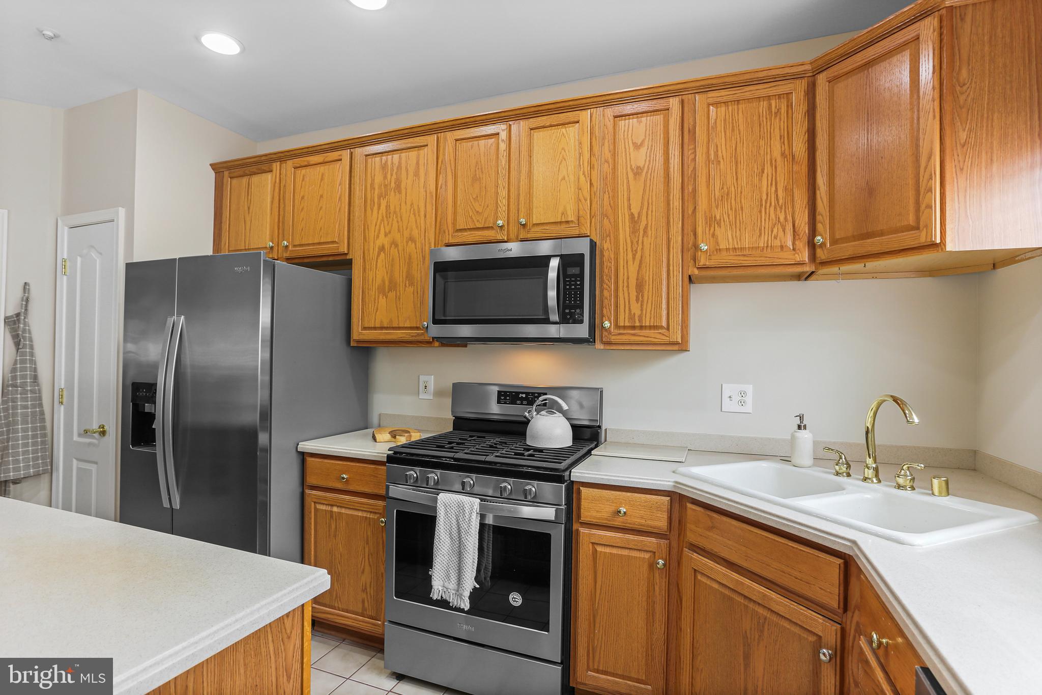 10232 Rutland Round Road, Unit 24 Columbia, MD 21044 - Photo 8 of 31 a kitchen with stainless steel appliances granite countertop a sink stove and refrigerator