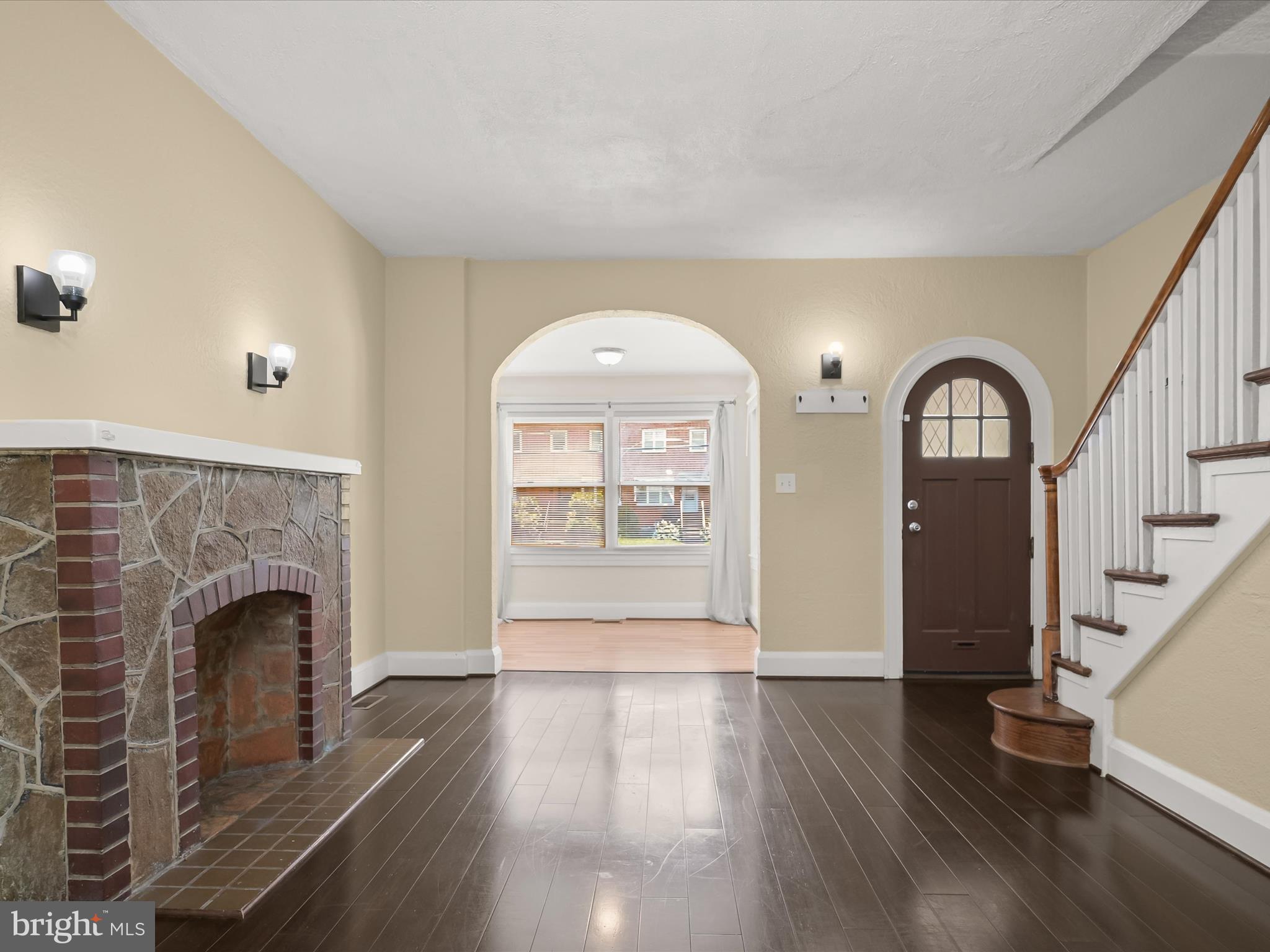 6204 Frederick Road Baltimore, MD 21228 - Photo 13 of 56 a view of livingroom with fireplace wooden floor and entryway