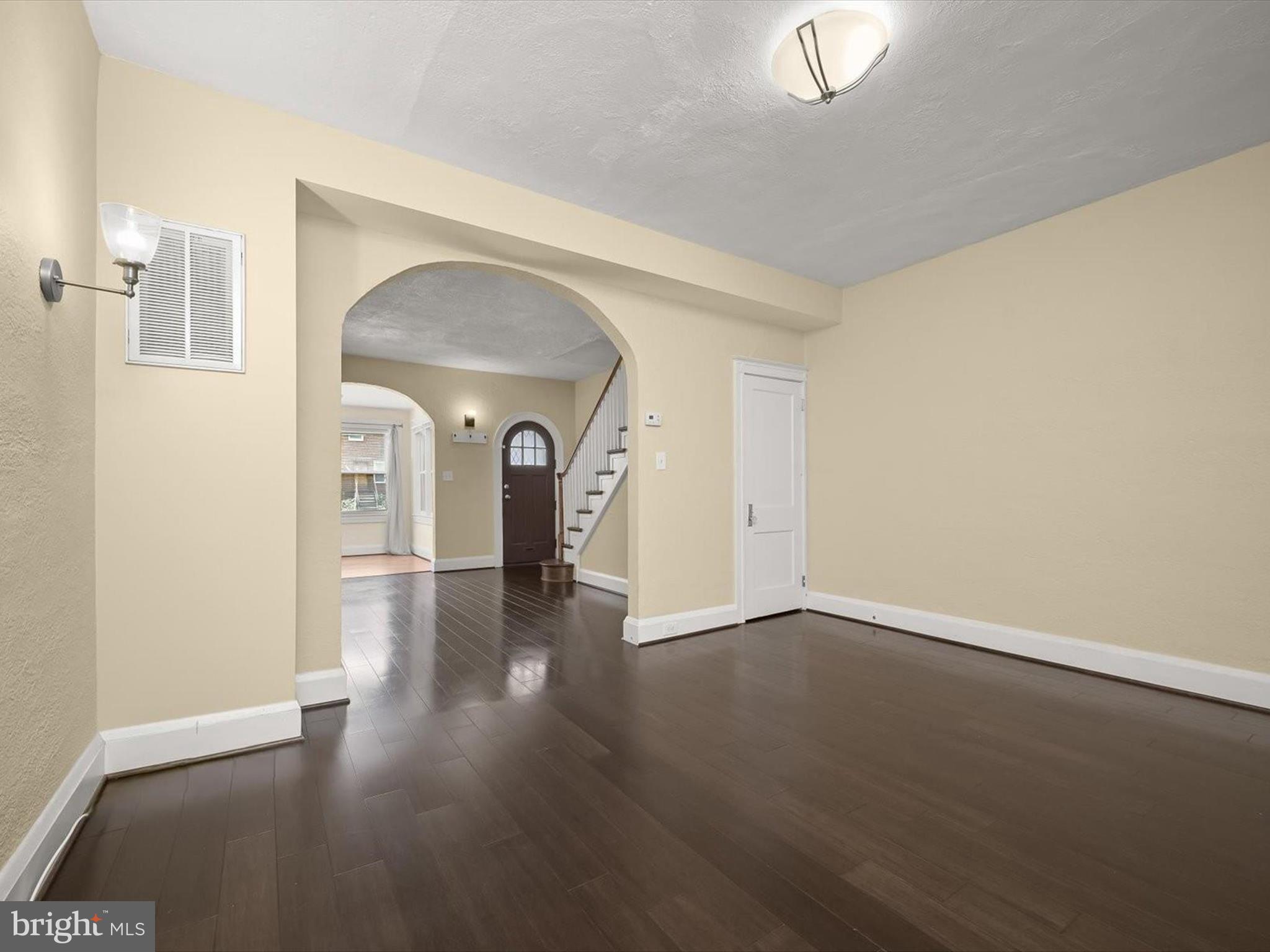 6204 Frederick Road Baltimore, MD 21228 - Photo 15 of 56 an empty room with wooden floor and windows