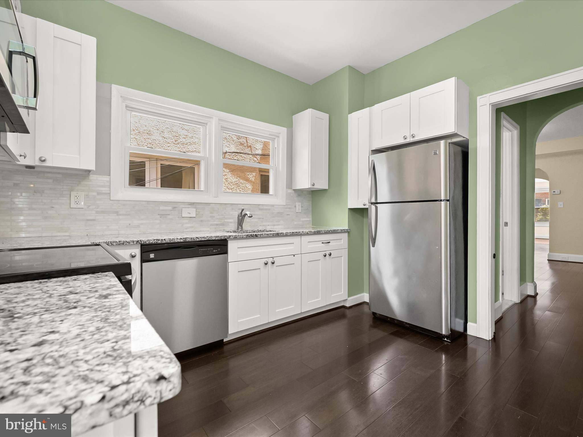 6204 Frederick Road Baltimore, MD 21228 - Photo 18 of 56 a kitchen with a refrigerator and a stove top oven