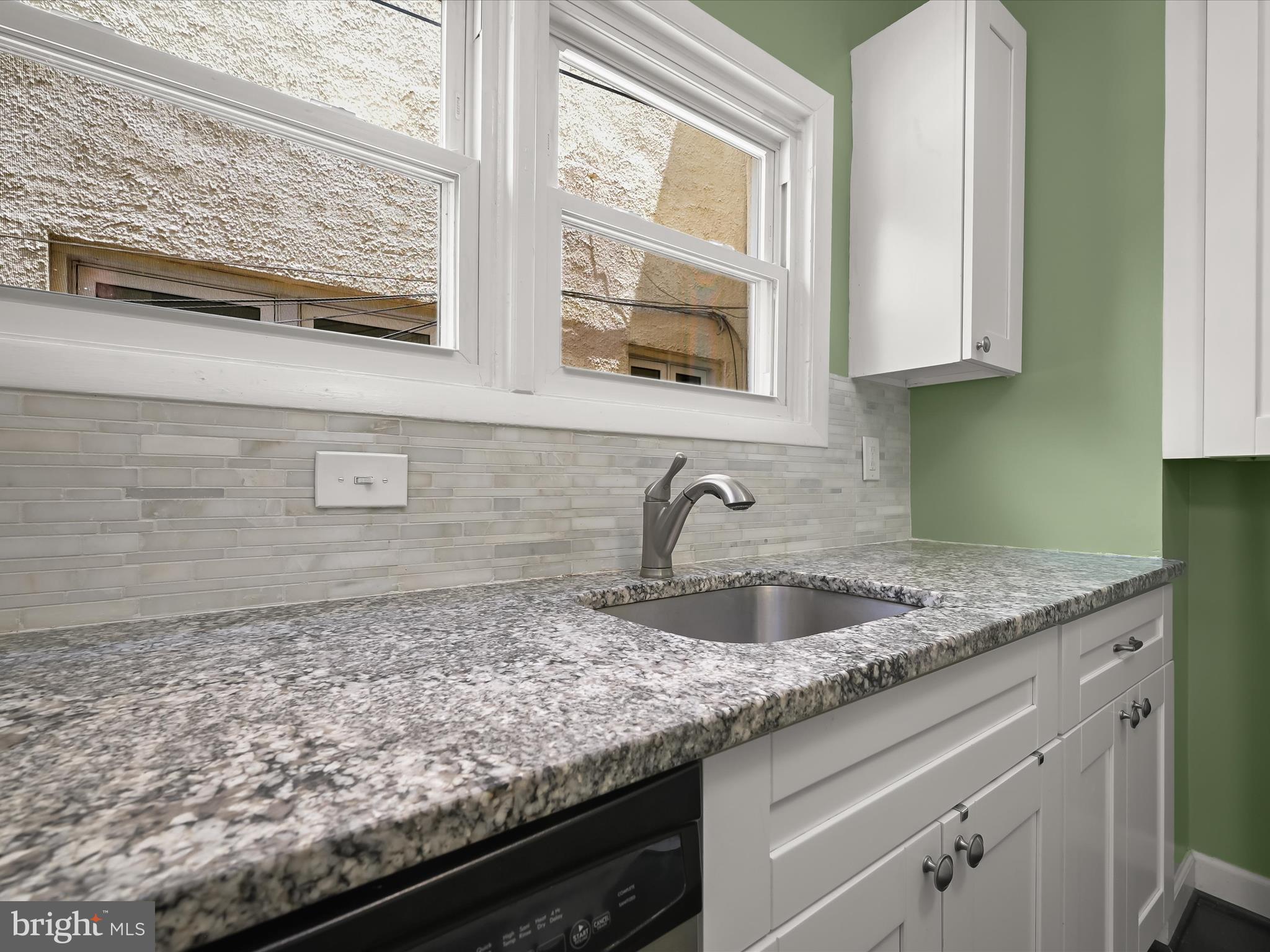 6204 Frederick Road Baltimore, MD 21228 - Photo 21 of 56 a kitchen with granite countertop a sink and a window
