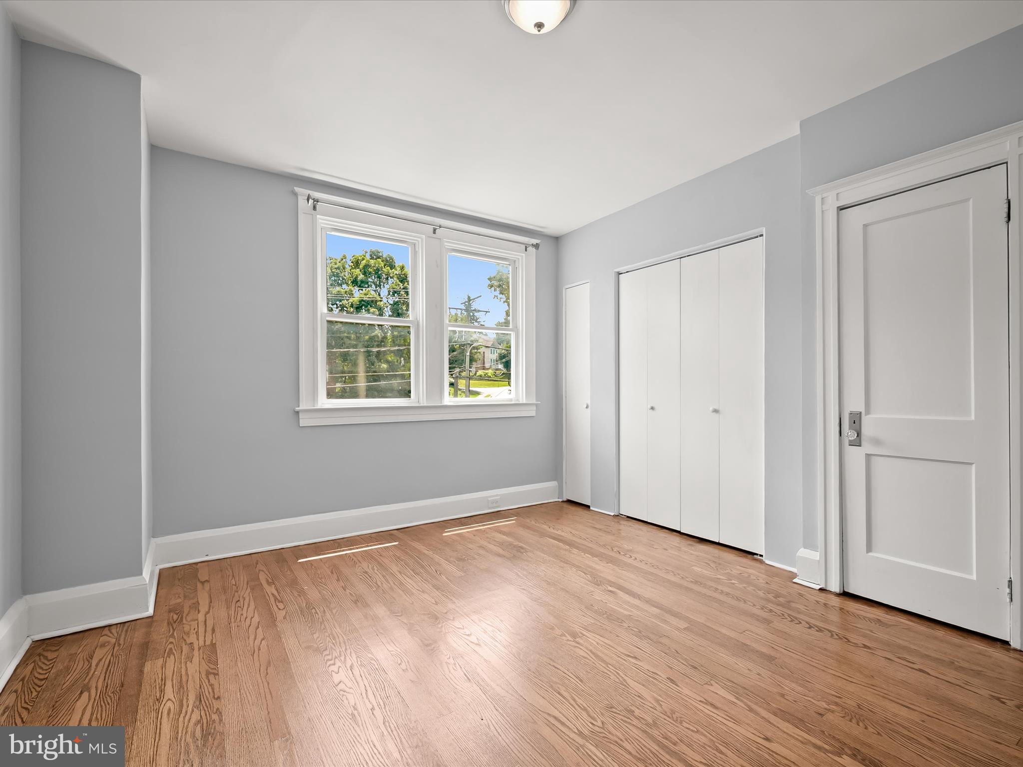 6204 Frederick Road Baltimore, MD 21228 - Photo 25 of 56 a view of an empty room with wooden floor and a window