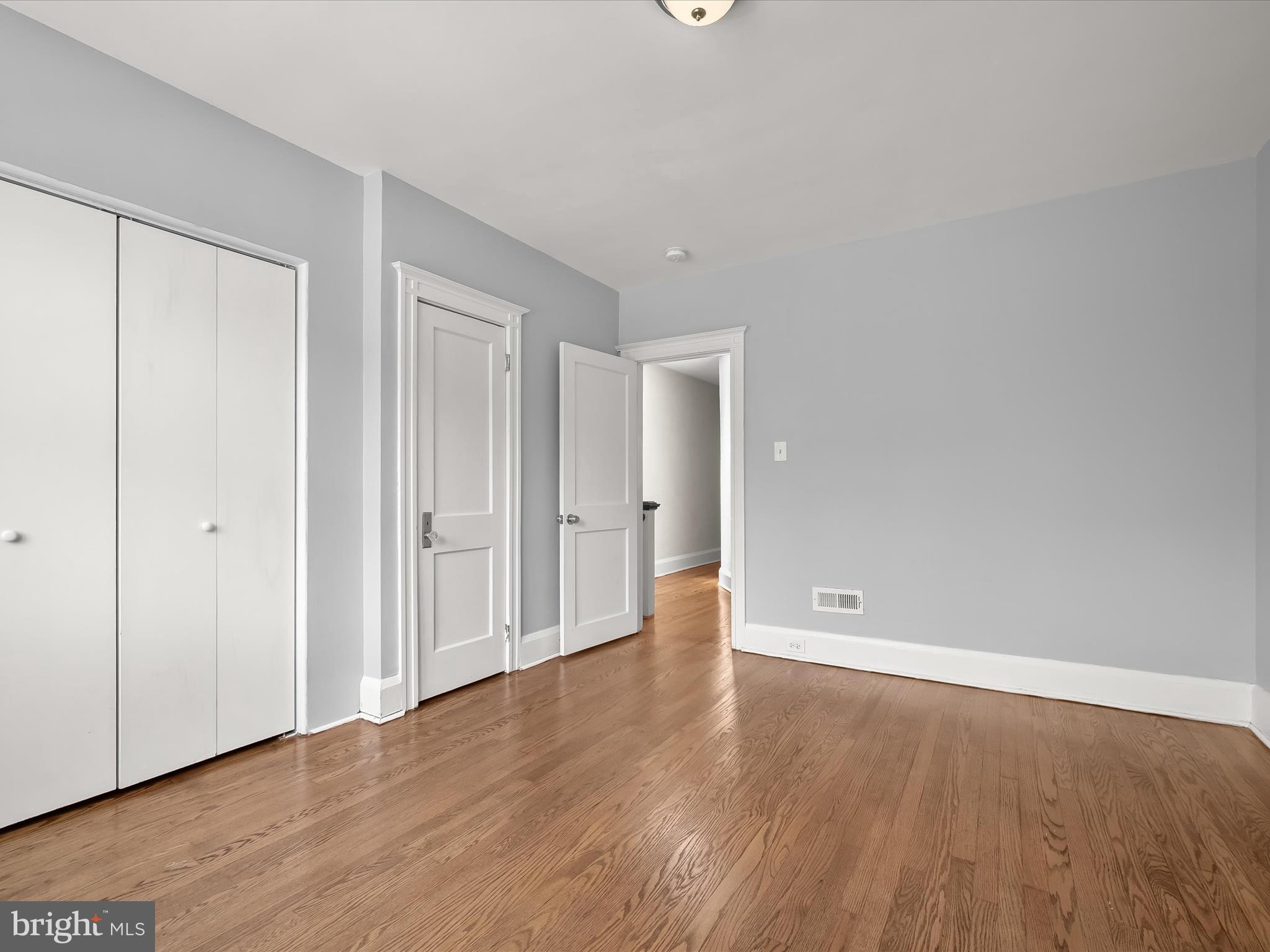 6204 Frederick Road Baltimore, MD 21228 - Photo 27 of 56 a view of an empty room with wooden floor