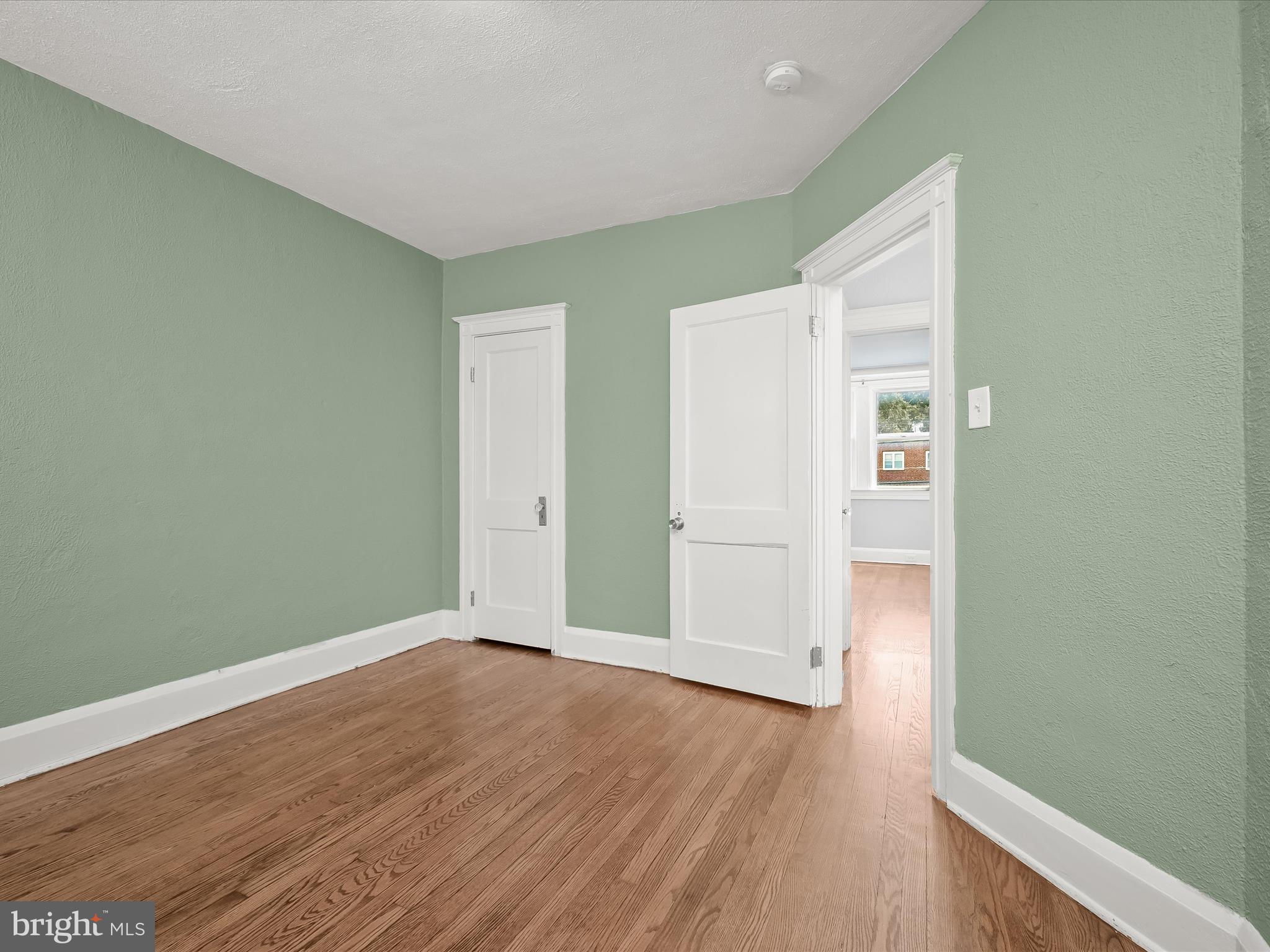 6204 Frederick Road Baltimore, MD 21228 - Photo 32 of 56 an empty room with wooden floor