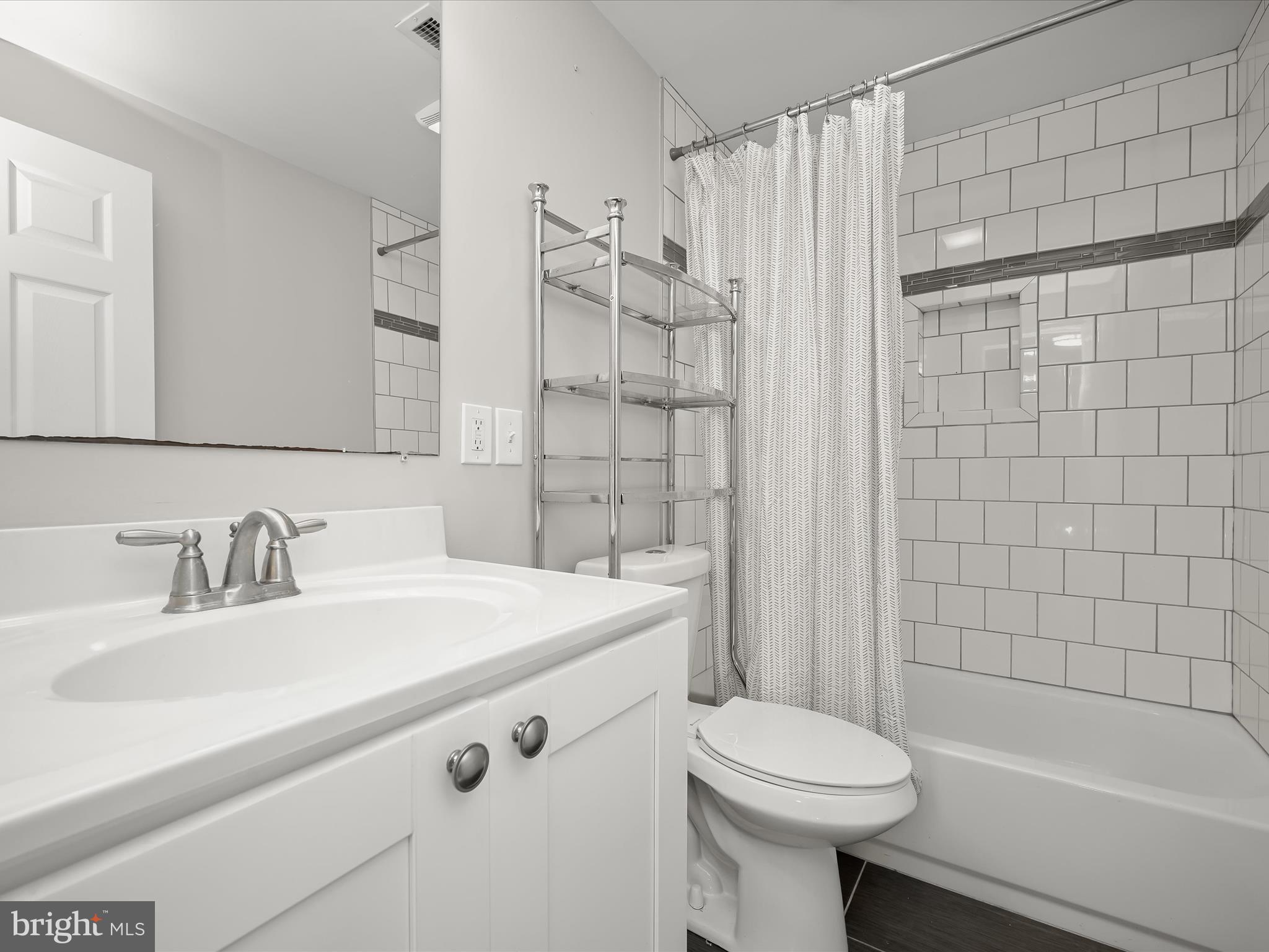 6204 Frederick Road Baltimore, MD 21228 - Photo 42 of 56 a bathroom with a sink toilet and shower
