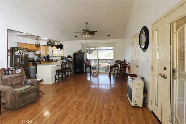 a living room with furniture a wooden floor and a chandelier