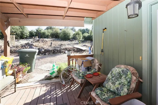 a view of a balcony with table and chairs potted plants with bedroom view