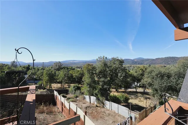 a view of a balcony with two chairs and a table
