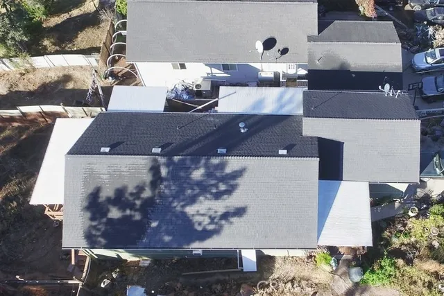 an aerial view of a house with a yard