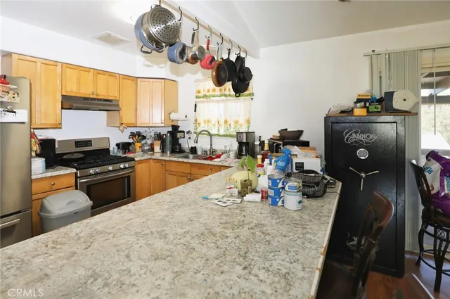 a kitchen with a sink appliances and cabinets