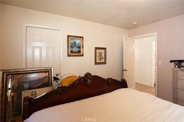 a bedroom with a bed and a tv