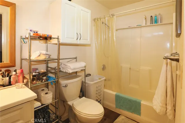 a white toilet sitting next to a bathroom sink