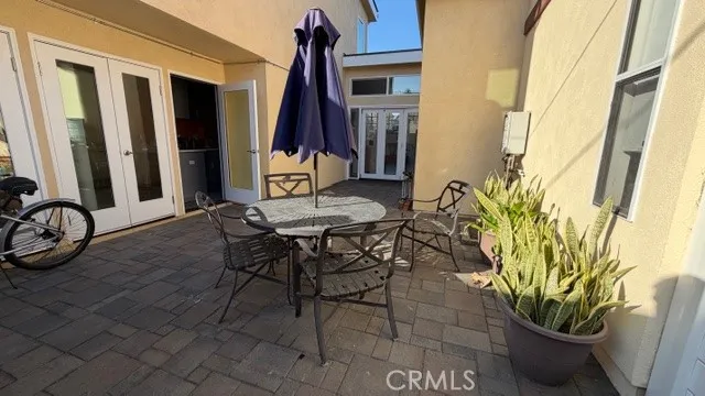a view of a patio with table and chairs and potted plants