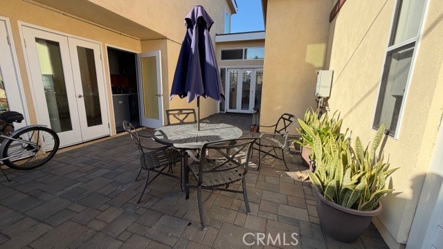 a view of a patio with table and chairs and potted plants