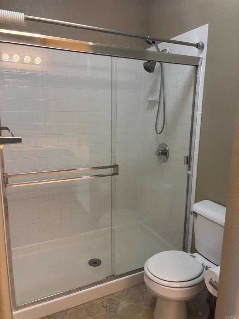 3575 Caminito El Rincon, Unit 216 San Diego, CA 92130 - Photo 12 of 14 a bathroom with a shower and a toilet