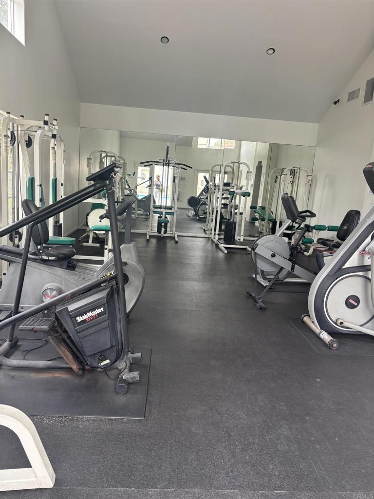 3575 Caminito El Rincon, Unit 216 San Diego, CA 92130 - Photo 4 of 14 a room with gym equipment and a view of living room