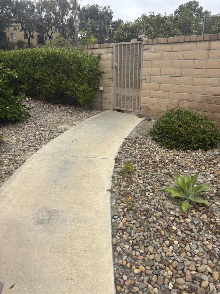 3575 Caminito El Rincon, Unit 216 San Diego, CA 92130 - Photo 6 of 14 a view of a pathway both side of building with yard