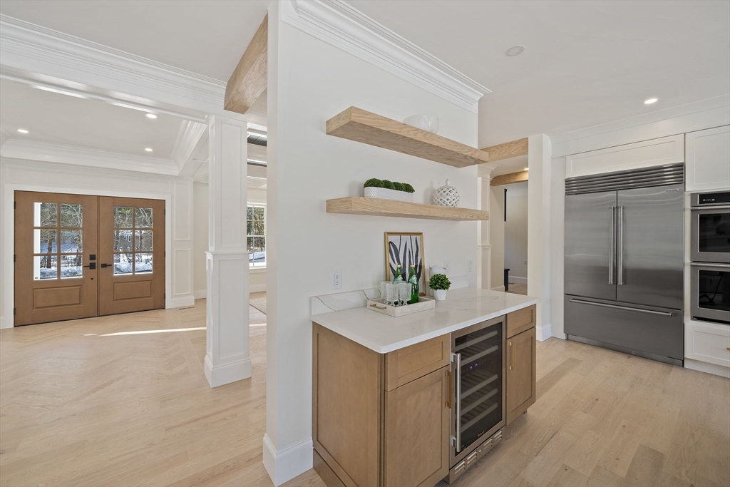 250 Center Street Hanover, MA 02339 - Photo 12 of 36 a kitchen with kitchen island white cabinets and refrigerator