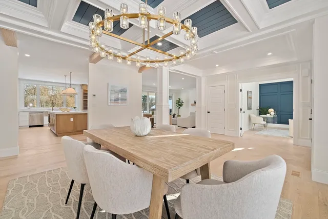 a view of a dining room with furniture and a chandelier fan