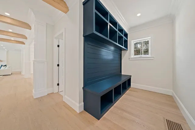 a hallway with cabinets and wooden floor