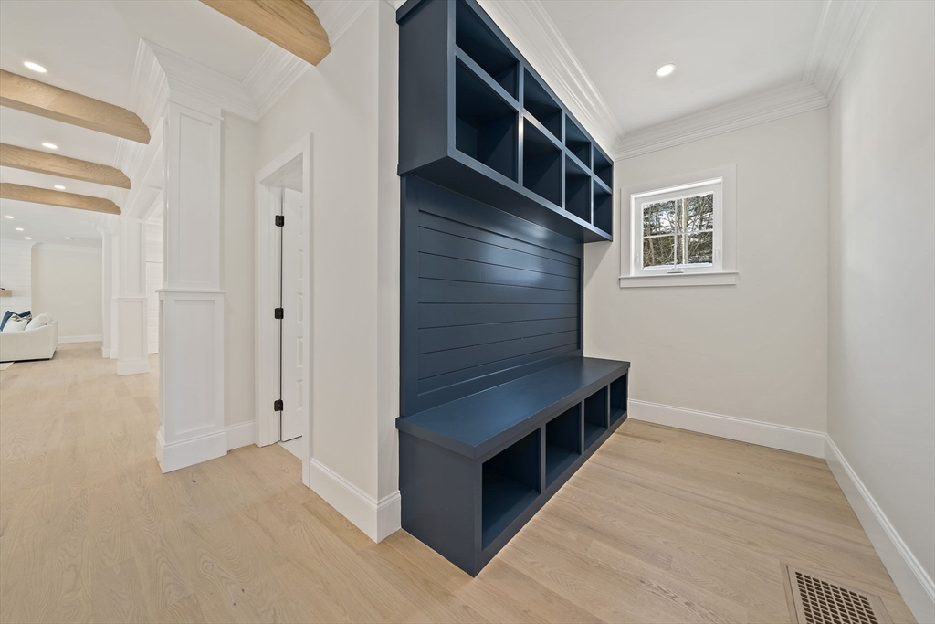 250 Center Street Hanover, MA 02339 - Photo 18 of 36 a hallway with cabinets and wooden floor