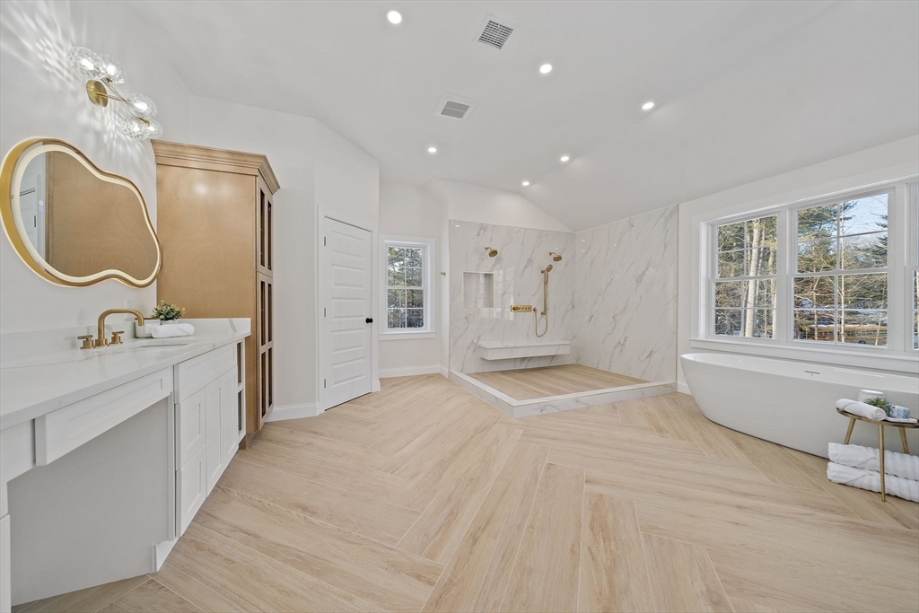 250 Center Street Hanover, MA 02339 - Photo 21 of 36 a spacious bathroom with a double vanity sink a large mirror and a bathtub