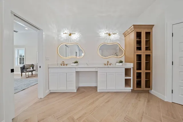 a view of kitchen with granite countertop a sink and dishwasher with white cabinets