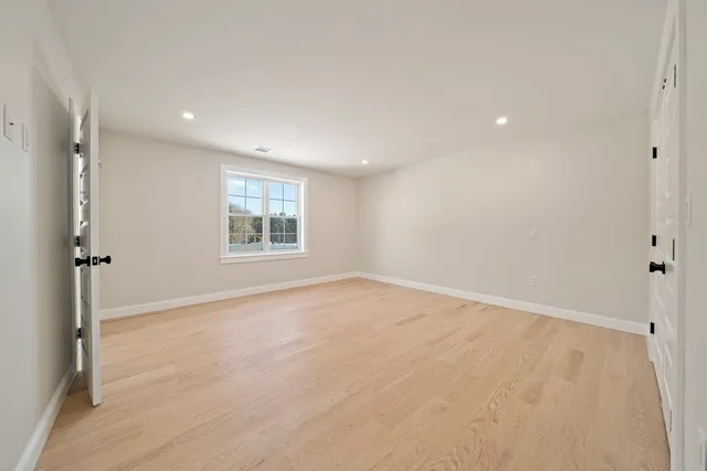 an empty room with windows and closet